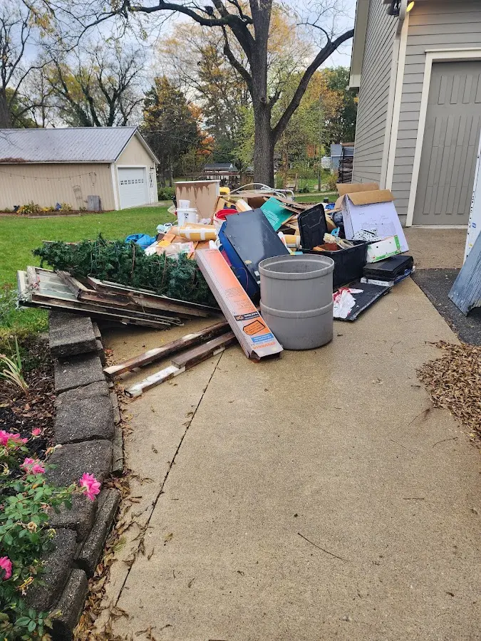 Dumpster being loaded with debris for 10 Yard Dumpster Rental in Griffith
